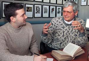 Paul Michael Lutzeler, Ph.D. (right), the Rosa May Distinguished University Professor in the Humanities and professor of German and comparative literature in Arts & Sciences, discusses a German novel with Kamaal Haque, a German and comparative literature major.