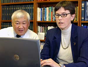 Carol S. North, M.D., professor of psychiatry, prepares interview material for the World Trade Center survival study with Barry Hong, Ph.D., professor of psychology in psychiatry and associate professor of medicine.