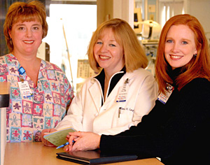 Fiona Levy credits her staff with the success of the PICU's quality care program. Levy (center) and key team members, assistant nurse manager Ali Cohen (left) and quality consultant Jamie McCollegan, review the tracking cards that have helped significantly enhance patient care.