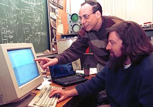 Martin H. Israel, Ph.D. (left), professor of physics in Arts & Sciences, and Lauren Scott, a doctoral student in physics, review data from TIGER (Trans-Iron Galactic Element Recorder), the University and NASA's balloon-borne experiment that recently completed a second flight over Antarctica to collect rare celestial atomic particles called cosmic rays. 