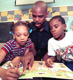 Recent Washington University graduate Glenn K. Davis reads to children at Ford Elementary School in St. Louis.