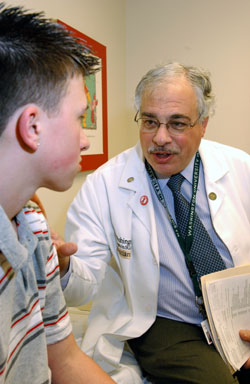 Neil White, M.D., director of the division of pediatric endocrinology and metabolism, sees 16-year-old diabetes patient Aaron Van Landuit for routine follow-up care.