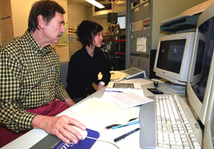 Ernst K. Zinner, Ph.D., research professor of physics and of earth and planetary sciences, and Ann Nguyen, a doctoral student in earth and planetary sciences, study a graphite grain in the NanoSIMS (Secondary Ion Mass Spectrometer) lab.