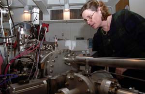 Christine Floss, Ph.D., senior research scientist in earth and planetary sciences and in physics, both in Arts & Sciences, checks the sample chamber of the NanoSIMS instrument on the fourth floor of Compton Hall. Floss has identified organic material in interplanetary dust particles, gathered from the Earth's stratosphere, that was made before the birth of our solar system. It is the first such organic material discovered.