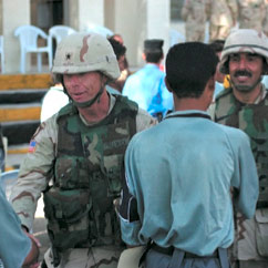 A U.S. Army brigadier general congratulates the graduates of the new police academy in Sin'Jar.