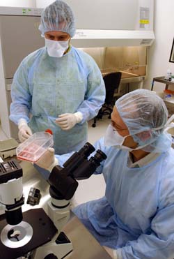 Research lab supervisor Jon Walker (left) and Good Manufacturing Practice (GMP) center Director Gerhard Bauer, M.D., prepare for a leukemia clinical trial, which will be led by John F. DiPersio, M.D., Ph.D., in the new state-of-the-art GMP at the Siteman Cancer Center.