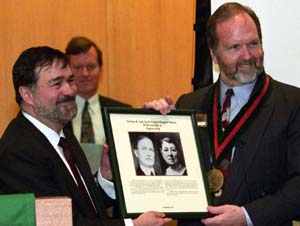 Christopher I. Byrnes, Ph.D. (left), dean of the School of Engineering & Applied Science and the Edward H. and Florence G. Skinner Professor of Systems Science and Mathematics, presents R. Martin Arthur, Ph.D., professor and interim chair of electrical and systems engineering, with a plaque at Arthur's installation as the Newton R. and Sarah Louisa Glasgow Wilson Professor of Engineering.