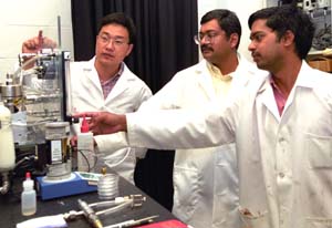 Pratim Biswas, Ph.D. (center), postdoctoral fellow Myonghwa Lee, Ph.D. (left), and doctoral student Prakash Kumar work with equipment used to synthesize monodispersed, nanometer-sized magnetic oxides that will be used in biomedical and environmental remediation applications.