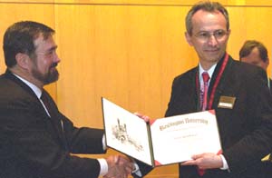 Christopher I. Byrnes, Ph.D. (left), dean of the School of Engineering & Applied Science and the Edward H. and Florence G. Skinner Professor of Systems Science and Mathematics, congratulates Gruia-Catalin Roman, Ph.D., professor and chair of computer science and engineering, at his installation as the Harold B. and Adelaide G. Welge Professor of Computer Science April 8 in Uncas A. Whitaker Hall for Biomedical Engineering.
