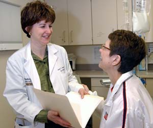 Janet S. Rader, M.D., associate professor of obstetrics and gynecology and of genetics, discusses the latest treatment options with patient Karen Robben. 