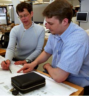Jacqueline Tatom, D.Des., assistant professor of architecture and director of the Master of Urban Design Program, works with architecture graduate student William Wells in a Givens Hall studio.