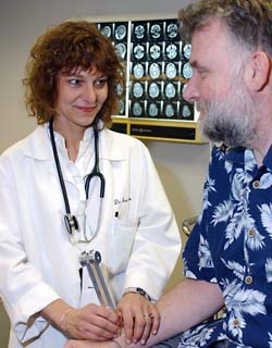 Anne H. Cross, M.D., tests the reflexes of patient David Chapman for a clinical trial. 