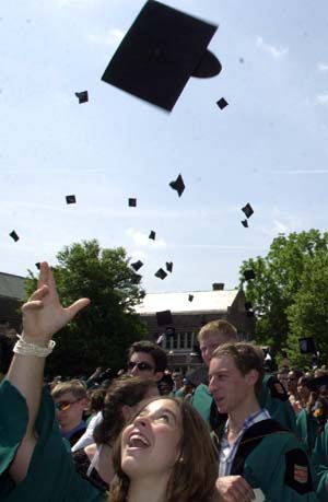 Maria Cristina Capelo throws up her mortarboard as she celebrates the close of the Commencement ceremony and the beginning of her life as a magna cum laude graduate of the College of Arts & Sciences. She was among more than 2,500 students receiving degrees today.