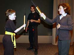 Jan Brunstrom, M.D., assistant professor of neurology and instructor of pediatrics, and cerebral palsy patient Emma Price demonstrate martial arts moves.