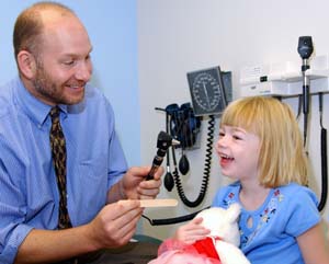 Andrew J. White, M.D., examines patient Helen Nelson. White says, 