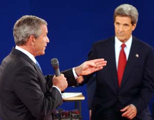 President George W. Bush makes a point as Sen. John Kerry looks on. Numerous sharp exchanges on several topics highlighted the 90-minute debate; at times, both candidates spoke over moderator Charles Gibson of ABC News.