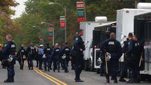 Dozens of police officers in riot gear prepare for duty on Forsyth Boulevard. Police from all over the state were bused to the Hilltop Campus for the Oct. 8 debate.
