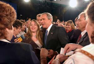 After the intense 90-minute debate, the mood lightened considerably as many of the 140 town-hall participants got autographs and took photographs with Kerry (top) and Bush (above).