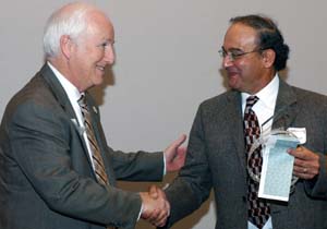 Larry J. Shapiro, M.D. (left), executive vice chancellor for medical affairs and dean of the medical school, congratulates Arbi Ben Abdallah, Ph.D., on receiving the Dean's Distinguished Service Award. Co-workers say Ben Abdallah is the glue that holds the department together.