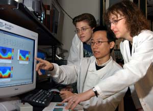 Dora E. Angelaki, Ph.D., graduate student Kim McArthur (left) and research associate Yong Gu, Ph.D., discuss data analyses for a project studying motion perception using a newly developed virtual reality apparatus that combines real motion and visual stimulation.