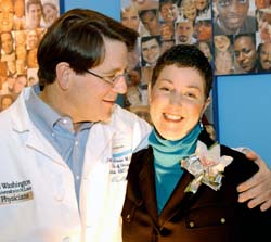 John DiPersio, M.D., the Lewis T. and Rosalind B. Apple Professor of Medicine, thanks Siteman patient Debra Ochs for recounting her battle with leukemia during the Jan. 4 news conference announcing Siteman's National Cancer Institute Comprehensive Cancer Center designation. Under DiPersio's care, Ochs underwent a successful bone marrow transplant last summer.