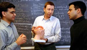 (From left) Adil Bashir, Ph.D., research associate, Dmitriy Yablonskiy, Ph.D., professor of radiology in the School of Medicine and of physics in Arts & Sciences, and Tariq Tanoli, M.D., research associate, discuss plans for a new imaging experiment. 