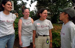 Stephanie Kurtzman (second from right), director of community service, talks with resident advisers (from left) Deepti Ramakrishnan, Meredith Reuter and Paola Rijos during Service First Sept. 4. Kurtzman started Service First, an initiative that introduces first-year University students to community service. In September, more than 1,000 University students volunteered their time to landscape, paint, clean and renovate 11 St. Louis public schools.