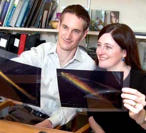 Michael R. Brent and Tamara L. Doering examine data from the *C. neoformans* microarray.  The husband-wife researchers had the rare chance to collaborate when they put their expertise to work on this genome sequencing project.