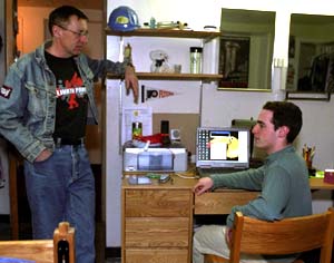 Glenn M. MacDonald, Ph.D., the John M. Olin Distinguished Professor of Economics & Strategy in the Olin School of Business, chats with a student during his weekly Friday afternoon walk around the first floor of Koenig Residence Hall.