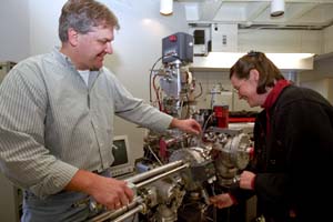 Husband-and-wife research team Frank Stadermann, Ph.D., and Christine Floss, Ph.D., examine the NanoSIMS in Compton Hall; their recent *Science* paper marks the fifth one in four years in that journal detailing a NanoSIMS discovery.