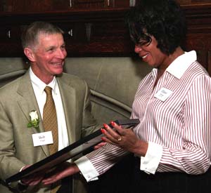 Robert L. Virgil presents a 2005 Gerry and Bob Virgil Ethic of Service Award to Elinor Nelson, who works in the University's financial services department. Nelson is the founder of 2000 Feet Inc., which provides shoes for children in the St. Louis area. The award was initially named the Sesquicentennial Ethic of Service Award, but it has been renamed to acknowledge the generous support of Geraldine J. and Robert Virgil and to recognize the couple's service to others.