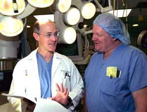 Bruce D. Lindsay, M.D. (left), discusses selecting a defibrillator for a patient with Dennis Fogarty, who has worked with Lindsay for more than 15 years as both a nurse in the electrophysiology lab and now as an employee of a company that manufactures defibrillators. 