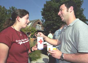 Senior Pamela Bookbinder, vice president of Student Union, collects money from senior Eli Zimmerman as part of Project S.O.S. (Students of the South) campaign. Spearheaded by senior Caroline Landry, who is from Lafayette, La., S.O.S is using 
