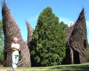 Environmental artist Patrick Dougherty with *Putting Two and Two Together* (2004), an installation at the Woodson Art Museum in Wausau, Wis. Dougherty will launch the Sam Fox School of Design & Visual Arts Visiting Artist Lecture Series Sept. 14.