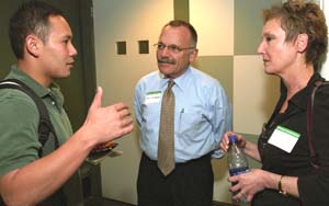 Bill Witbrodt (center), director of Student Financial Services, and Marilyn Pollack, interim director of Dining Services, chat with Liet Le Sept. 9 in Simon Hall during an orientation session for students attending WUSTL from areas affected by Hurricane Katrina. Le, a joint M.D./M.B.A. student, is from Biloxi, Miss. He was studying at Tulane University but is now one of nearly 80 undergraduate and graduate students from affected areas who have enrolled at Washington University on a visiting, non-degree-seeking basis.