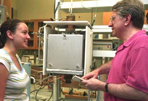 Bruce Fegley, Ph.D., professor of earth and planetary sciences in Arts Sciences, talks with laboratory assistant Laura Schaefer. The two scientists have performed difficult calculations that have reinvigorated one of the most famous and controversial theories on the origins of life, the 1953 Miller-Urey experiment.