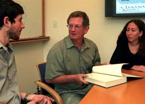 Yoram Rudy, Ph.D. (center), discusses his work with students Tom O'Hara and Lina El-Esber. Rudy has joint appointments in the departments of Cell biology, physiology, medicine, radiology and pediatrics, and he is the director of a new interdisciplinary entity, the Cardiac Bioelectricity and Arrhythmia Center.