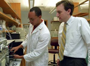 Donald Elbert, Ph.D. (right), works with graduate student Evan Scott in a laboratory in Whitaker Hall.