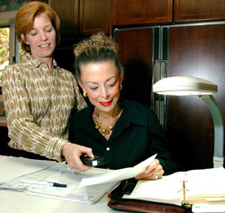 As part of the Occupational Therapy In-home and Community Home Services program, Perlmutter (left) checks the lighting at a work area of client Gay Hirsch, who has low vision.