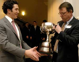 Mark C. Pydynowski (left), co-founder of Somark Innovations Inc., accepts the 2005 Olin Cup from Ken Harrington, managing director of the Skandalaris Center for Entrepreneurial Studies. Pydynowski and his partner, Ramos M. Mays, will receive $50,000 in investment capital to continue building their business.