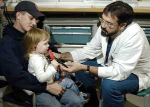 Bo Kennedy, M.D., lets 2-year-old Jordan Schneider check out his stethoscope. Kennedy treated Jordan for a dislocated elbow in the St. Louis Children's Hospital Emergency Department.