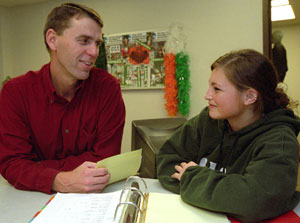 Assistant Athletic Director Joe Worlund, here with senior volleyball player Nicole Hodgman, has served in a variety of roles in his 24 years at the University.