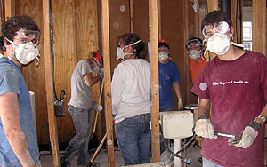 A group of WUSTL students work to repair a New Orleans home damaged by Hurricane Katrina. More than 200 students traveled to hurricane-affected areas during spring break to assist with major clean up efforts there.