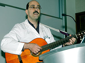 Arie Perry, M.D., sings one of the songs he wrote to second-year medical students in neuropathology.