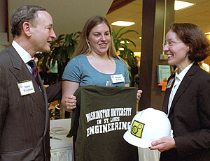 Chancellor Mark S. Wrighton and EnCouncil President Maggie L. Gierse present Mary J. Sansalone, Ph.D., with a WUSTL T-shirt and hardhat at a welcoming reception April 10 in Lopata Hall. Sansalone, professor of structural engineering at Cornell University, will become dean of the School of Engineering & Applied Science July 1.