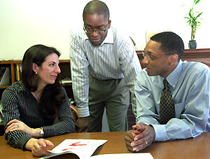 (From left) Jennie Iverson, Ph.D., and Jamel Donnor, Ph.D., postdoctoral fellows, chat with William F. Tate, Ph.D., the Edward Mallinckrodt Distinguished University Professor in Arts & Sciences and chair of the Department of Education in Arts & Sciences, in his office.