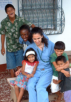 Second-year medical students Funmi Okuyemi (left) and Amanda Raya with new friends in front of a medical clinic that a group of 11 students set up in Bluefields, Nicaragua, over spring break. Two of the children were seen as patients at the clinic.