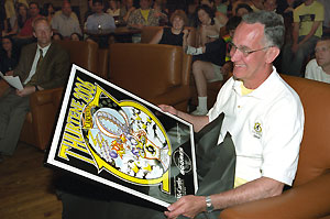 Jim Burmeister was presented with a framed Thurtene 2006 poster, among other gifts. Looking on at left is Henry Biggs, Ph.D., assistant dean in Arts & Sciences, the new Thurtene adviser.