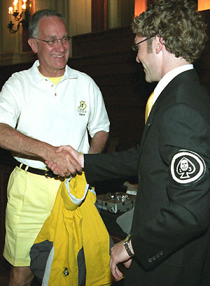 Jim Burmeister, outgoing adviser to Thurtene, receives a jacket from Dan Sarbacker, Thurtene alumni adviser, during a party honoring Burmeister April 22 in Holmes Lounge.