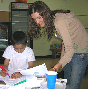 Nicole Solawetz helps second-grader Guadalupe Hernandez make a T-shirt as part of a twice-a-week tutoring program at Acción Social Comunitaria, a nonprofit organization that provides support services to Hispanic families on the city's south side.